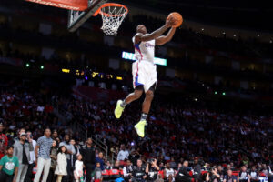 A BASKETBALL PLAYER’S INCREDIBLE VERTICAL LEAP TO GRAB A REBOUND