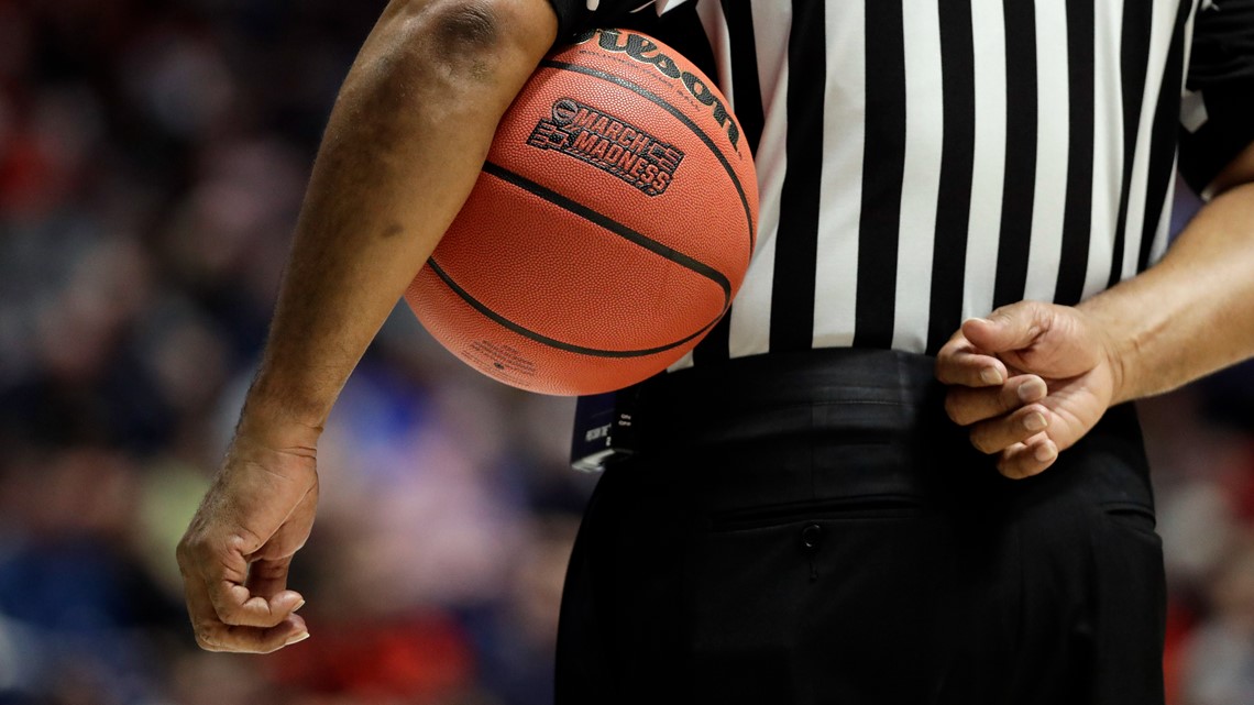 A BASKETBALL REFEREE TOSSES THE BALL STRAIGHT: MASTERING PRECISION AND FAIR PLAY